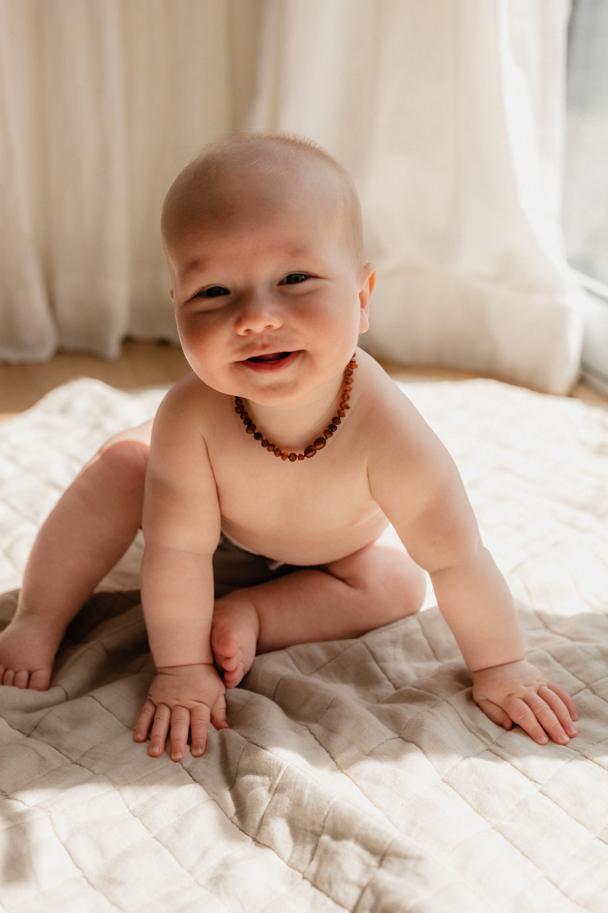 Baby wearing Largo amber teething necklace