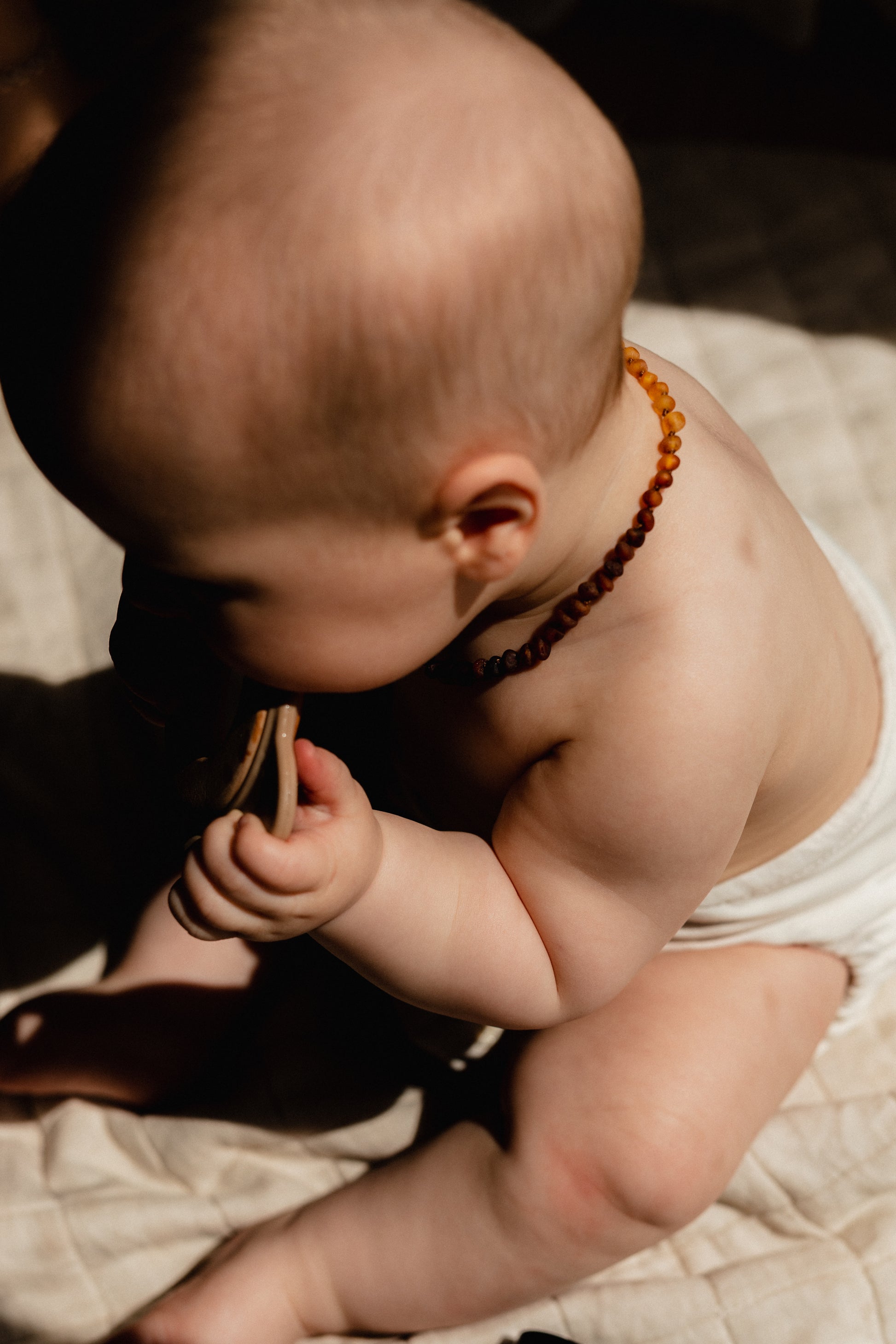 Baby wearing Largo Teething necklace side view